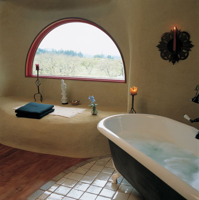 Because there’s no bathroom door, a beautiful view of the orchard can be enjoyed from the straw bale window seat as well as the tub.
